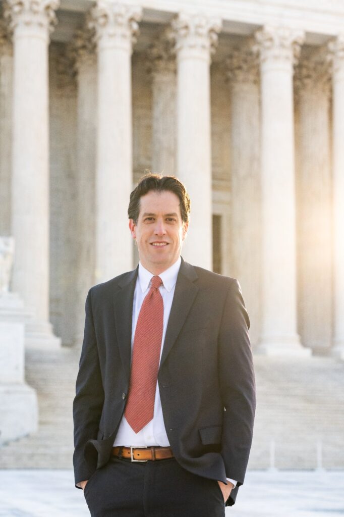 Adam Fomby in front of the Supreme Court columns