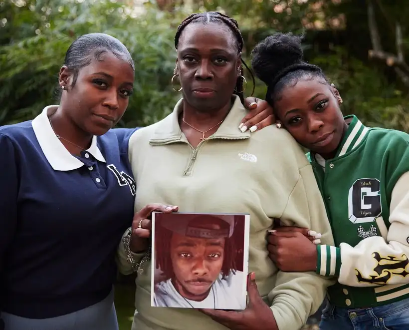 Ashtian Barnes’s family holding his photograph