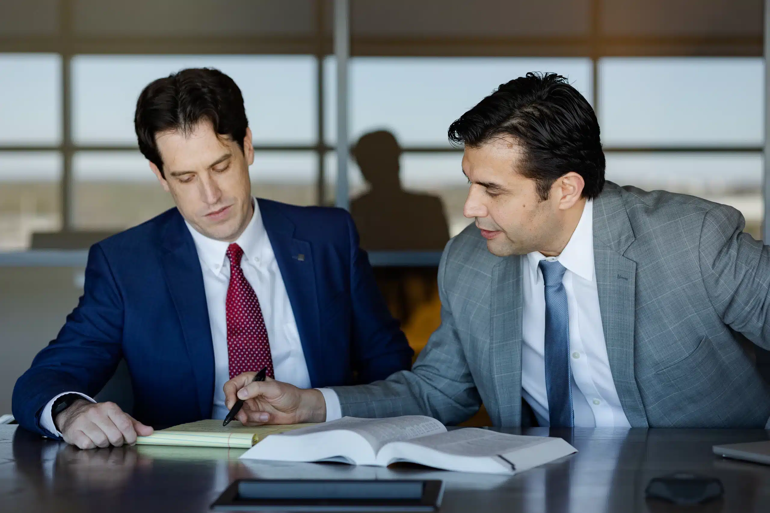 Adam Fomby and Jorge Borunda, partners at Borunda & Fomby, reviewing a case in their Houston office.